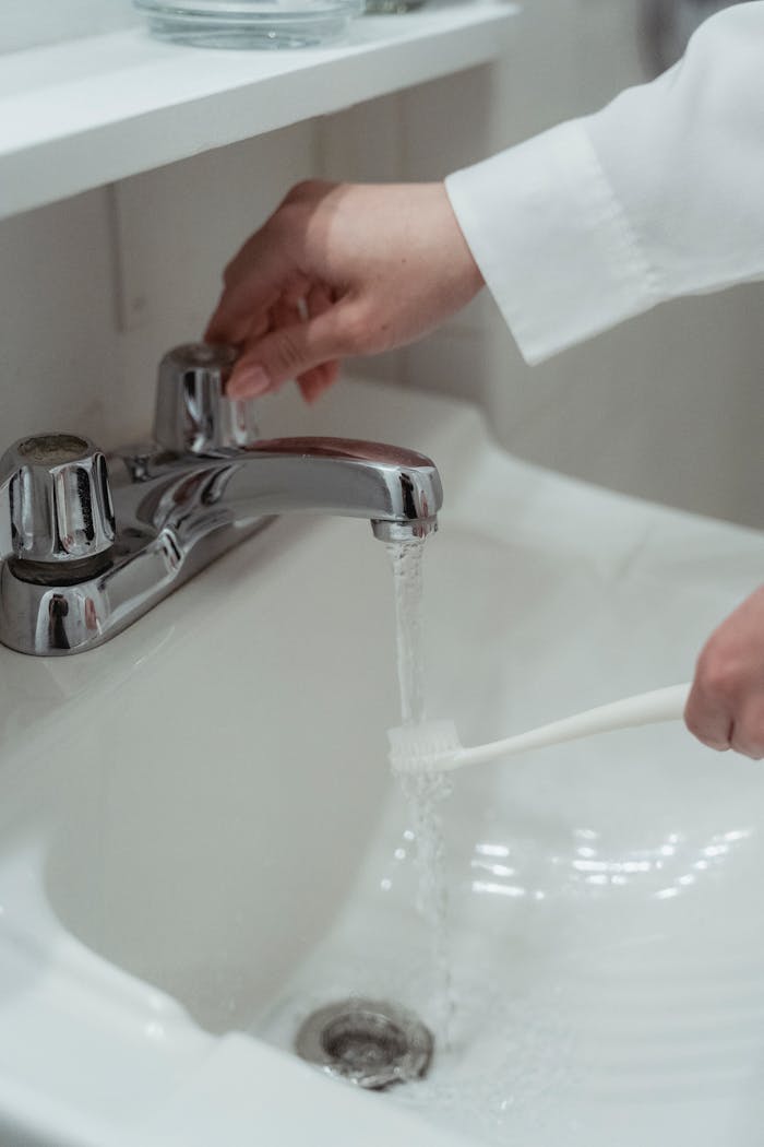 Person Washing Toothbrush 